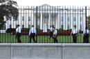 Uniformed Secret Service officers walk along the fence on the North side of the White House in Washington, Saturday, Sept. 20, 2014. The Secret Service is coming under intense scrutiny after a man who hopped the White House fence made it all the way through the front door before being apprehended. (AP Photo/Susan Walsh)