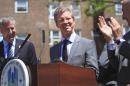 Joined by Mayor Bill de Blasio, left, and Sen. Charles Schumer, right, Housing and Urban Development Secretary Shaun Donovan, center, is greeted at a press conference at the Jacob Riis Houses on Monday June 2, 2014 in New York. Secretary Donovan announced the winners of four designs, chosen from a pool of 10 finalists as a part of the 