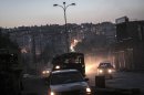 In this Tuesday, Oct. 30, 2012 photo, night falls on a Syrian rebel checkpoint in the Bustan Al-Pasha neighborhood, the boundary of the area controlled by rebel fighters at the northeast limit of the Kurdish controlled area of Sheikh Maksoud in Aleppo, Syria. (AP Photo/Narciso Contreras)