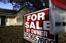 In this photo made Tuesday, Dec. 16, 2014, a for sale by owner sign sits in front of a home in Richardson, Texas. Mortgage company Freddie Mac releases weekly mortgage rates on Thursday, Dec. 18, 2014. (AP Photo/LM Otero)