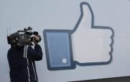 A television photographer shoots the Like sign outside of Facebook headquarters in Menlo Park, Calif., Friday, May 18, 2012. Facebook CEO Mark Zuckerberg symbolically opened trading on the Nasdaq stock market inside Facebook headquarters in Menlo Park. Facebook stock is starting trading today, available to the general public for the first time. The social networking site, which was started in a college dorm room eight years ago, would be valued at more than $100 billion according to the price set for shares ahead of today's trading. (AP Photo/Paul Sakuma)