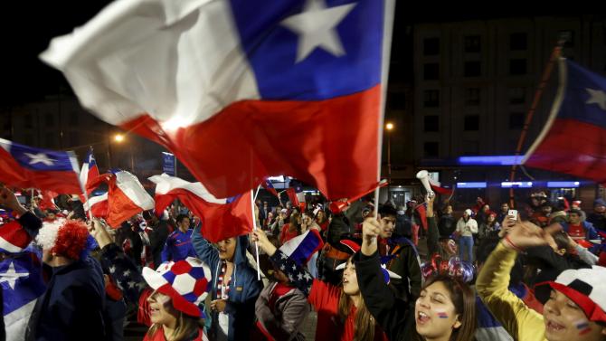 Chilean fans celebrate along the streets in Concepcion following Chile&#39;s victory over Peru in their Copa America semi-final soccer match in Santiago, Chile