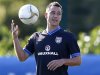 England's John Terry catches the ball during a soccer training session in London Colney