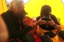 In this May 22, 2013 photo distributed by Miura Dolphins Co. Ltd., 80-year-old Japanese extreme skier Yuichiro Miura, left, uses oxygen mask and his son, Gota sips green tea as they take a rest in a tent at their South Col camp at 8,000 meters (26,247 feet) before their departure for Camp 5 during their attempt to scale the summit of Mount Everest. Miura, who climbed Mount Everest five years ago, but just missed becoming the oldest man to reach the summit, was back on the mountain Wednesday to make another attempt at the title. (AP Photo/Miura Dolphins Co. Ltd.) MANDATORY CREDIT