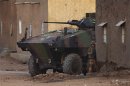A French soldier stands next to an armoured vehicle during an operation to collect explosives found in a house in Gao