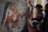 In this undated photo made available by National Geographic, conservator Angelyn Bass cleans and stabilizes the surface of a wall of a Maya house that dates to the 9th century A.D. in the Maya city Zultun in northeastern Guatemala. Archaeologists have found the small room where royal scribes apparently used walls like a blackboard to keep track of astronomical records and the society's intricate calendar some 1,200 years ago. Anthony Aveni of Colgate University, along with William Saturno of Boston University and others, are reporting the discovery in the Friday, May 11, 2012 issue of the journal Science. (AP Photo/National Geographic, Tyrone Turner)
