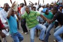 Striking miners dance and cheer after they were informed of a 22 percent wage increase offer outside Lonmin's Marikana mine