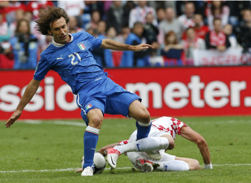 Italy's Andrea Pirlo, left, is fouled by Croatia's Mario Mandzukic during the Euro 2012 soccer championship Group C match between Italy and Croatia in Poznan, Poland, Thursday, June 14, 2012. (AP Photo/Antonio Calanni)