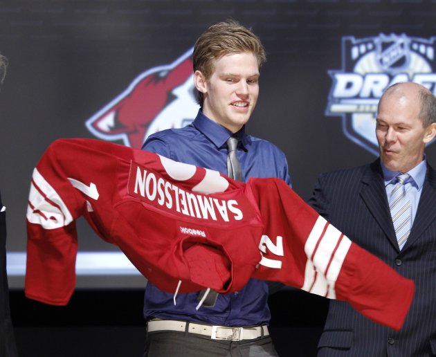 Henrik Samuelsson puts on his new jersey after being picked by the Phoenix Coyotes in the first round of the NHL Draft