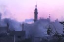 In this image made from amateur video released by the Shaam News Network and accessed Monday, June 25, 2012, smoke rises from buildings following purported shelling in Talbeesa, Homs, Syria. (AP Photo/Shaam News Network via AP video) TV OUT, THE ASSOCIATED PRESS CANNOT INDEPENDENTLY VERIFY THE CONTENT, DATE, LOCATION OR AUTHENTICITY OF THIS MATERIAL