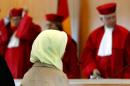 Picture taken on September 24, 2003 in Karlsruhe, southern Germany, shows Muslim teacher Fereshta Ludin and lawyers of the German Constitutional Court after a verdict was spoken on wearing a headscarf in class
