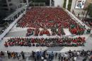 Students gather to break the Guinness World Record, for dressing as Santa's elves, in Bangkok