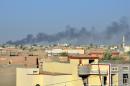 Smoke rises from buildings after shelling on the Iraqi city of Fallujah, on May 4, 2014