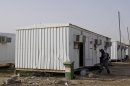 An Iraqi soldier inspects prefabricated houses at Camp Liberty near Baghdad's airport on February 17, 2012