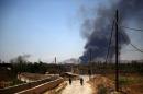 A general view shows heavy smoke rising after rebel fighters reportedly fired mortar shells targeting sites belonging to Syrian regime forces in Arbeen, on the outskirts of Damascus, on May 16, 2015