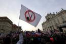Demonstrators hold flags as they attend an anti-immigrants rally in Prague