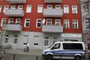 A German police van stands in front of a house in Berlin