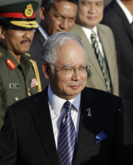 Malaysian Prime Minister Najib Razak arrives at Villamor Air Base at suburban Pasay city, south of Manila, Sunday Oct. 14, 2012. Najib is here for a three-day official visit, highlight of which is to witness the formal signing of a tentative peace agreement between the government and the Moro Islamic Liberation Front (MILF) of which Malaysia helped broker. (AP Photo/Bullit Marquez)