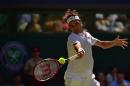 Switzerland's Roger Federer hits a return against Bosnia-Herzegovina's Damir Dzumhur during their men's singles first round match on day two of the 2015 Wimbledon Championshipsin southwest London, on June 30, 2015