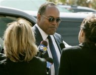 Former NFL star and actor O.J. Simpson talks with reporters as he arrives for the funeral of attorney Johnnie Cochran in Los Angeles, April 6, 2005. REUTERS/Fred Prouser