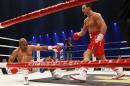 IBF, WBA, WBO and IBO champion Wladimir Klitschko from Ukraine, right, knocks down his Australian challenger Alex Leapai during their heavyweight world title bout in Oberhausen, western Germany, Saturday, April 26, 2014. (AP Photo/Frank Augstein)