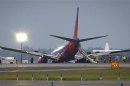 Southwest Airlines Boeing 737 sits on the tarmac at LaGuardia airport, after making an emergency landing without its nose gear, in New York