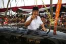 Indonesia's presidential candidate Prabowo Subianto gestures as he leaves a campaign rally in Ciparay near Bandung, West Java