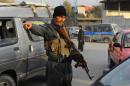 An Afghan policeman gestures to a motorist at a checkpoint in Kabul on November 18, 2013