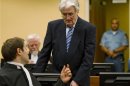 Former Bosnian Serb leader Karadzic talks to member of his legal team Sladojevic in the courtroom in The Hague
