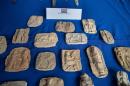 Ancient Iraqi clay reliefs are seen during a ceremony to repatriate more than 60 Iraqi cultural items which had been smuggled into the US, at the Iraqi consulate in Washington, DC, on March 16, 2015