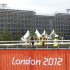 Workers carry scaffolding next to the Riverbank Arena in the Olympic Park in the 2012 Summer Olympics, Sunday, July 15, 2012, in London. The Riverbank Arena will be the hockey competition venue during the Olympics.  (AP Photo/Jae Hong)