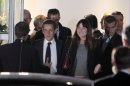 President and conservative candidate for re-election, Nicolas Sarkozy, center left, and his wife Carla Bruni-Sarkozy, center right, leave a TV studio after his campaign debate, in Saint-Denis, outside Paris, Wednesday May 2, 2012. France's presidential race hit a dramatic pitch Wednesday in the only face-to-face debate between President Nicolas Sarkozy and front-running challenger Francois Hollande - a verbal slugfest that broke little new ground on substance but exposed big differences in style. (AP Photo/Thibault Camus)
