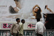 An Indian man watches a poster of Bollywood film “Jism 2”
    displayed outside a cinema in Hyderabad, India, Thursday, Aug. 2, 2012.
    "Jism 2" stars a hard-core porn actress, and it does have
    that pesky title. But it’s not a porn movie. Bollywood is certainly not
    ready for that. The film, which will be released across India on Friday,
    is pushing the ever-widening sexual boundaries enjoyed by many in urban
    India. (AP Photo/Mahesh Kumar A.)