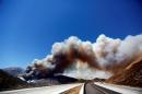 A huge plume of smoke crosses over Interstate 15 during the Blue Cut fire at the Cajon Pass in San Bernardino County, California