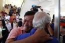 Cambodian former Khmer Rouge survivors, Soum Rithy, left, and Chum Mey, right, embrace each other after the verdicts were announced at the U.N.-backed war crimes tribunal in Phnom Penh, Cambodia, Thurdday, Aug. 7, 2014. Three and a half decades after the genocidal rule of Cambodia's Khmer Rouge ended, the tribunal on Thursday sentenced two top leaders of the former regime to life in prison on war crimes charges for their role in the country's terror period in the 1970s. (AP Photo/Heng Sinith)