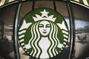 The Starbucks logo hangs on a window inside a newly designed Starbucks coffee shop in Fountain Valley, Californi
