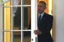 U.S. President Obama walks out from the Oval Office of the White House in Washington