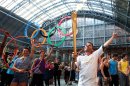In this photo provided by LOCOG, Daniel Mccubbin holds the Olympic Flame inside St Pancras International Railway Station on Day 69 of the London 2012 Olympic Torch Relay, Thursday July 26, 2012, in London. (AP Photo/LOCOG, Gareth Fuller)
