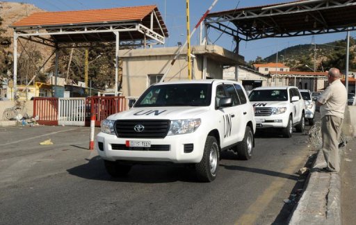 A convoy of UN vehicles carrying a team of experts at the Lebanon-Syria border following their arrival on September 30, 2013