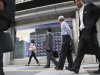 People walk by an electronic stock indicator in Tokyo Wednesday, Sept. 12, 2012 as Japan's Nikkei 225 index rose 1.7 percent to close at 8,959.96. (AP Photo/Shizuo Kambayashi)