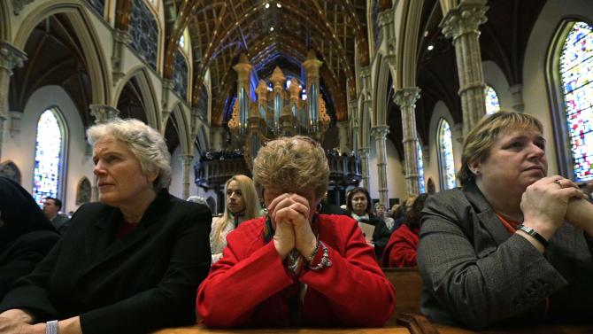 Mourners pray during the funeral Mass for Cardinal Francis George at Holy Name Cathedral in Chicago, Thursday, April 23, 2015. George died Friday, April 17 at age 78 after a long battle with cancer. (AP Photo/Nam Y. Huh, Pool)