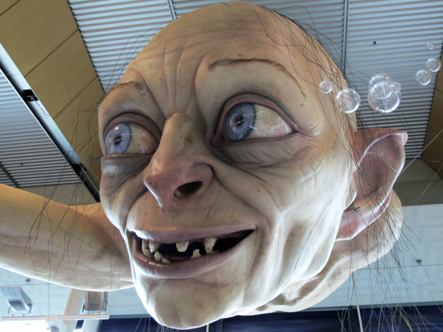 In this photo taken Saturday, Nov. 24, 2012, a giant sculpture of Gollum, a character from "The Hobbit," is displayed in the Wellington Airport to celebrate the upcoming premiere of the first movie in the trilogy, in Wellington, New Zealand. The sculpture was created at Weta Workshop, part of Peter Jackson's movie empire in the Wellington suburb of Miramar. The world premiere of "The Hobbit: An Unexpected Journey" is Nov. 28 at Wellington's Embassy Theatre. (AP Photo/Nick Perry)