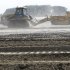 In this May 22, 2012, photo, heavy equipment is used to move sand in a farm field in Missouri Valley, Iowa. Hundreds of farmers in Iowa and Nebraska are still struggling to remove sand and fill holes gouged by the Missouri River, which swelled last summer with rain and snowmelt and overflowed onto thousands of acres of farmland. (AP Photo/Charlie Neibergall)