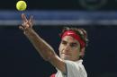Federer of Switzerland serves to Rosol of the Czech Republic during their men's singles match at the ATP Dubai Tennis Championships