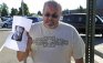 Tom Sullivan holds up a photo of his son Alex Sullivan pleading the media to help find him, outside Gateway High School a few blocks from the scene of the Century 16 Theatre shootings in Aurora
