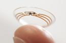This undated photo released by Google shows a contact lens Google is testing to explore tear glucose. After years of scalding soldering hair-thin wires to miniaturize electronics, Brian Otis, Google X project lead, has burned his fingertips so often that he can no longer feel the tiny chips he made from scratch in Google's Silicon Valley headquarters, a small price to pay for what he says is the smallest wireless glucose sensor that has ever been made. (AP Photo/Google)