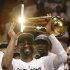 Miami Heat shooting guard Dwyane Wade holds the the Larry O'Brien NBA Championship Trophy after Game 5 of the NBA finals basketball series against the Oklahoma City Thunder, Friday, June 22, 2012, in Miami. The Heat won 121-106 to become the 2012 NBA Champions.(AP Photo/Lynne Sladky)
