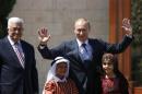 Palestinian President Abbas and Russian counterpart Putin stand with children during a welcoming ceremony in Bethlehem