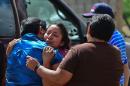 Relatives of a victim of the truck accident cry during the funeral in Santa Rosa, Mexico, on July 30, 2015