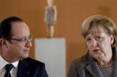 German Chancellor Angela Merkel and French President Hollande arrive for dinner with representatives of European Round Table of Industrialists in Berlin